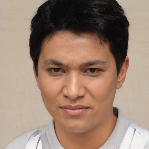 Joyful asian young-adult male with short  black hair and brown eyes