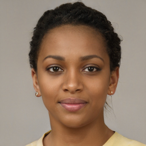 Joyful black young-adult female with short  brown hair and brown eyes