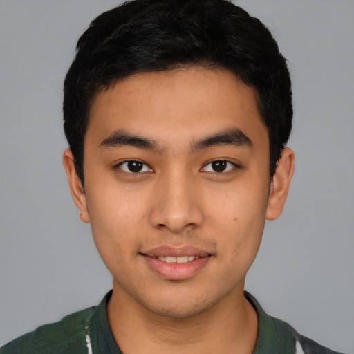 Joyful latino young-adult male with short  black hair and brown eyes