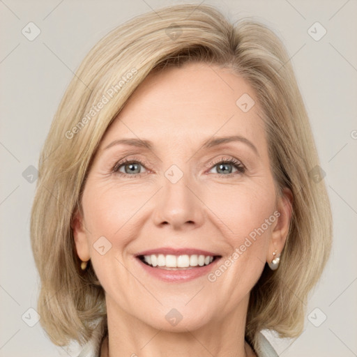 Joyful white adult female with medium  brown hair and green eyes