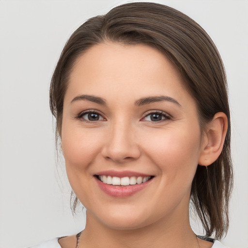 Joyful white young-adult female with medium  brown hair and brown eyes