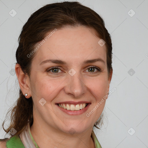 Joyful white young-adult female with medium  brown hair and green eyes