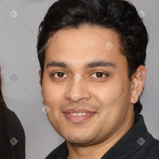 Joyful white young-adult male with short  black hair and brown eyes