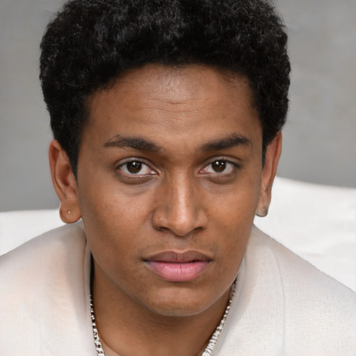 Joyful black young-adult male with short  brown hair and brown eyes