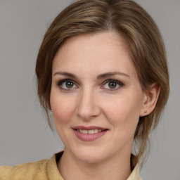 Joyful white young-adult female with medium  brown hair and grey eyes