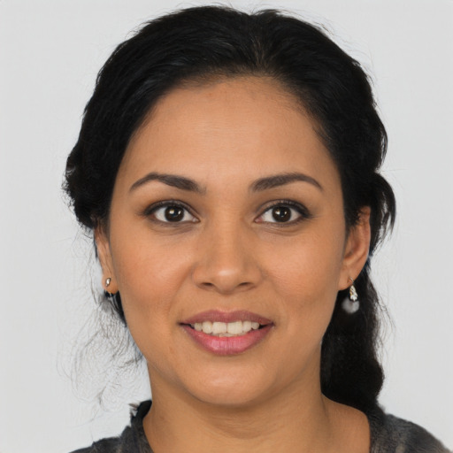 Joyful latino young-adult female with medium  black hair and brown eyes
