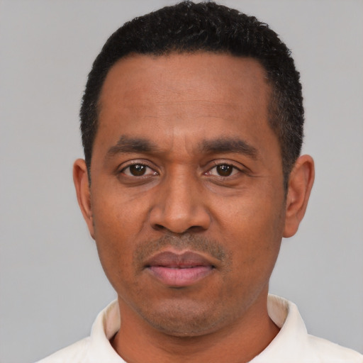 Neutral latino adult male with short  black hair and brown eyes