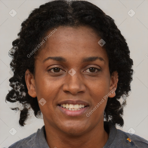 Joyful black adult female with short  brown hair and brown eyes