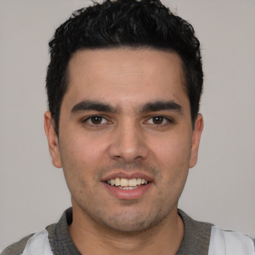 Joyful white young-adult male with short  black hair and brown eyes