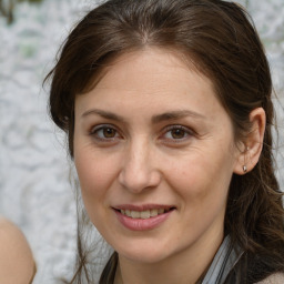 Joyful white adult female with long  brown hair and brown eyes