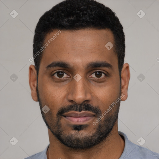 Joyful black young-adult male with short  black hair and brown eyes
