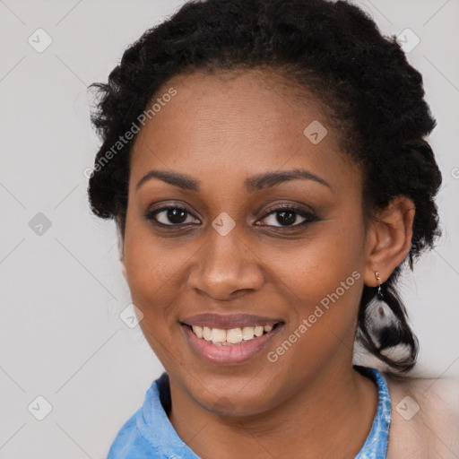 Joyful black young-adult female with medium  black hair and brown eyes