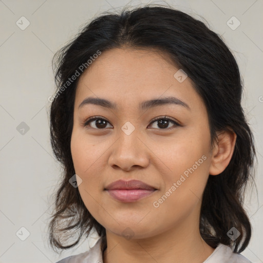 Joyful latino young-adult female with medium  brown hair and brown eyes