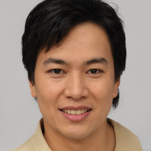 Joyful asian adult female with short  brown hair and brown eyes