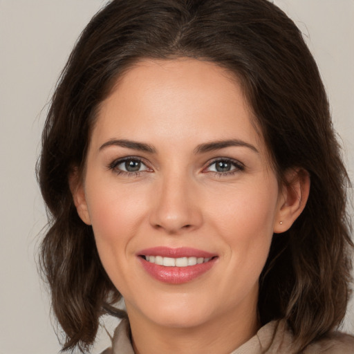 Joyful white young-adult female with medium  brown hair and brown eyes