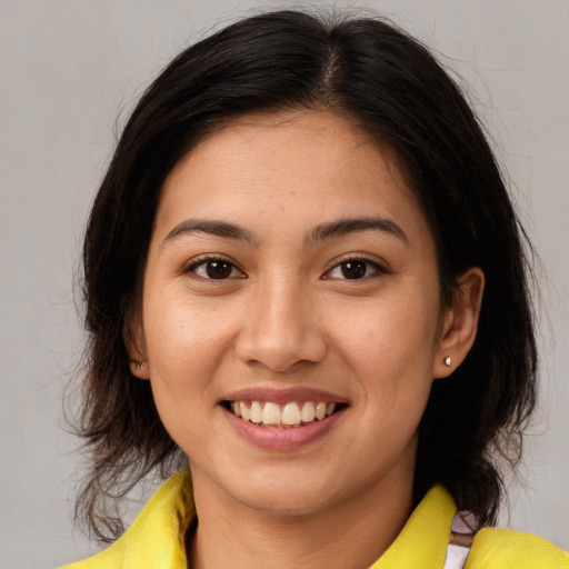 Joyful white young-adult female with medium  brown hair and brown eyes