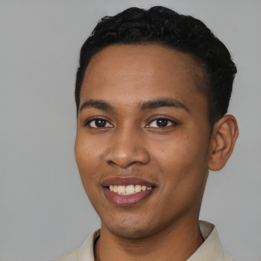 Joyful black young-adult male with short  black hair and brown eyes