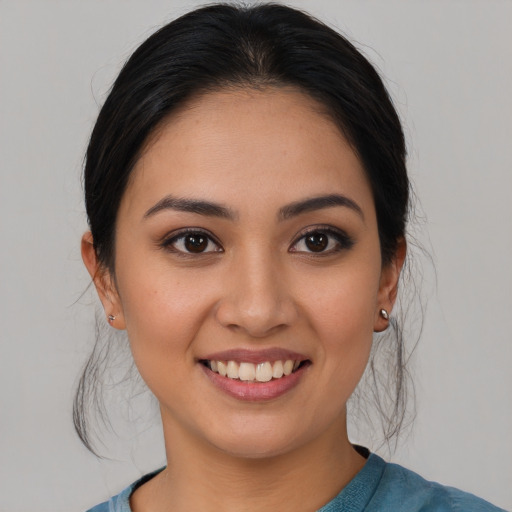 Joyful asian young-adult female with medium  brown hair and brown eyes