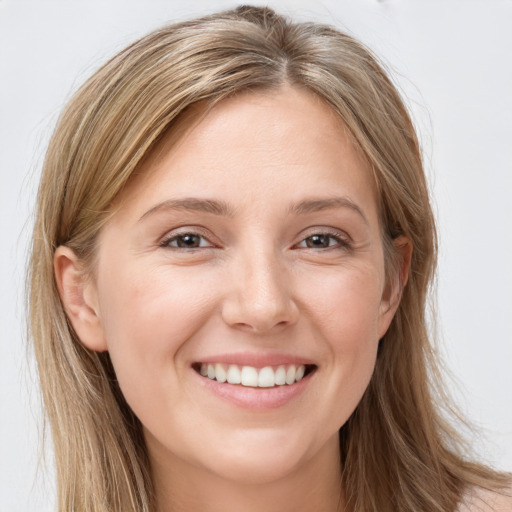 Joyful white young-adult female with long  brown hair and brown eyes