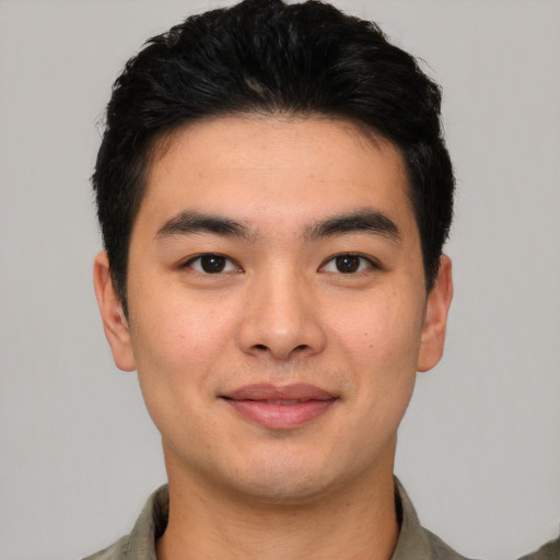 Joyful asian young-adult male with short  black hair and brown eyes