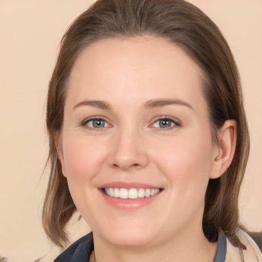 Joyful white young-adult female with medium  brown hair and grey eyes