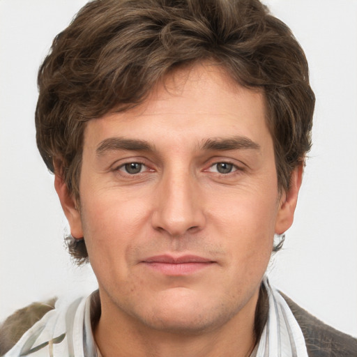 Joyful white adult male with short  brown hair and grey eyes