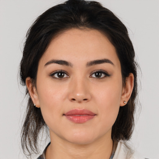 Joyful latino young-adult female with medium  brown hair and brown eyes