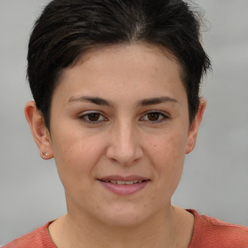 Joyful white young-adult female with short  brown hair and brown eyes