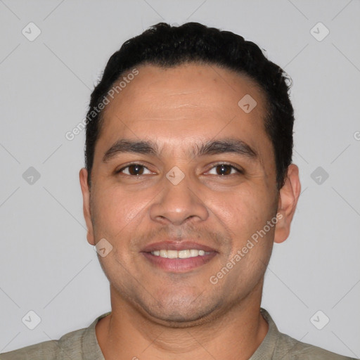 Joyful latino young-adult male with short  black hair and brown eyes