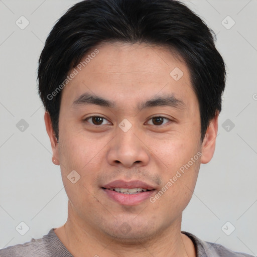 Joyful asian young-adult male with short  brown hair and brown eyes