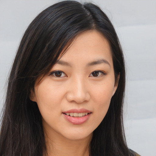 Joyful asian young-adult female with long  brown hair and brown eyes
