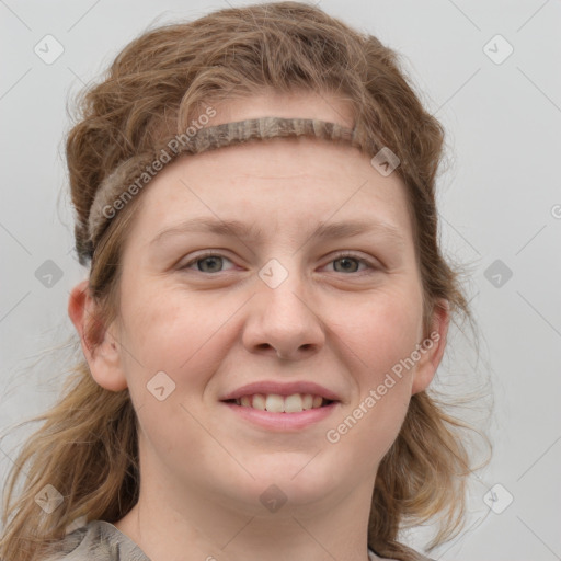 Joyful white young-adult female with medium  brown hair and blue eyes