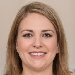 Joyful white young-adult female with long  brown hair and grey eyes