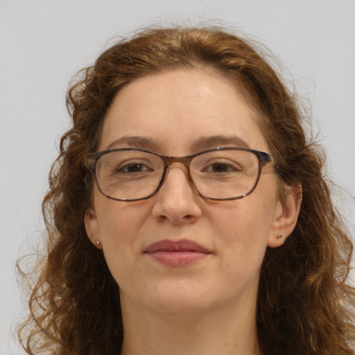 Joyful white adult female with long  brown hair and green eyes