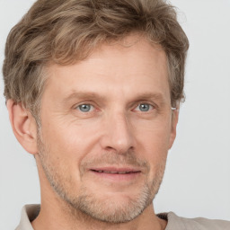 Joyful white adult male with short  brown hair and grey eyes