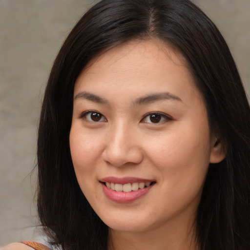 Joyful asian young-adult female with long  brown hair and brown eyes