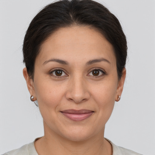 Joyful white adult female with short  brown hair and brown eyes