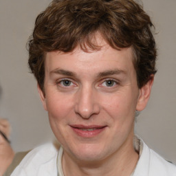 Joyful white adult male with medium  brown hair and brown eyes