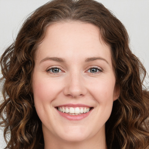 Joyful white young-adult female with long  brown hair and green eyes