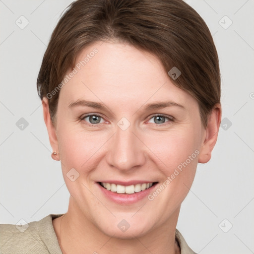 Joyful white young-adult female with short  brown hair and grey eyes