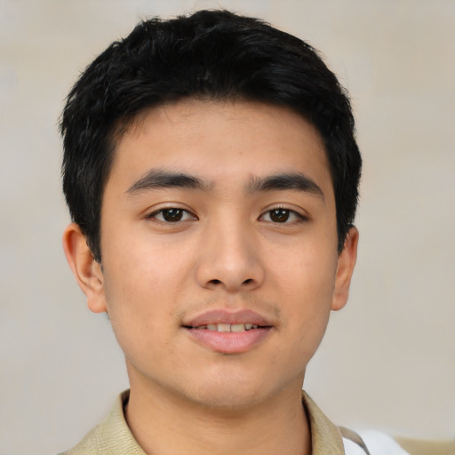 Joyful asian young-adult male with short  black hair and brown eyes