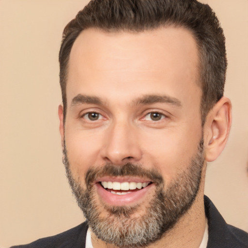 Joyful white adult male with short  brown hair and brown eyes