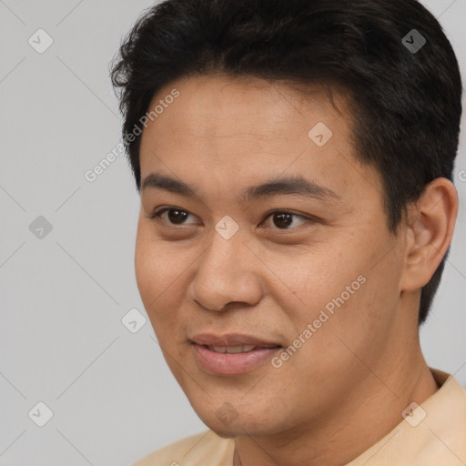 Joyful asian young-adult male with short  brown hair and brown eyes