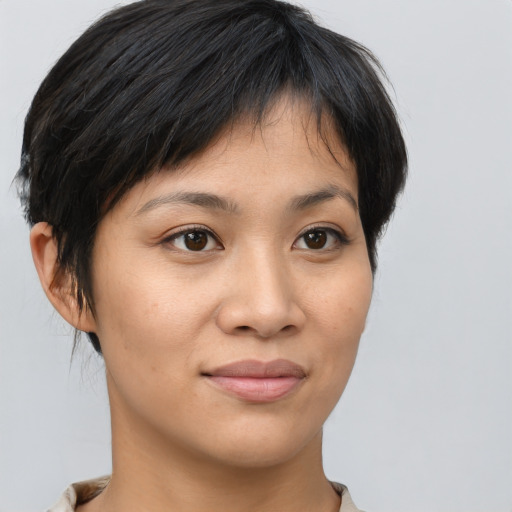Joyful asian young-adult female with short  brown hair and brown eyes