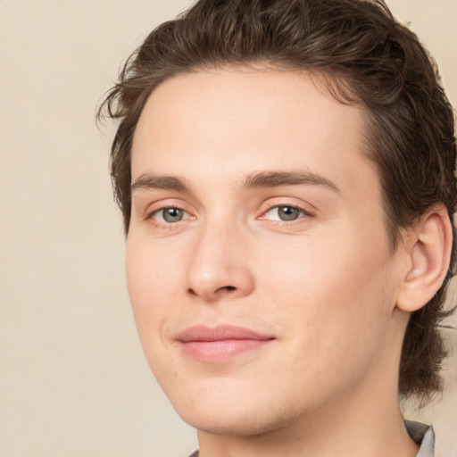 Joyful white young-adult male with medium  brown hair and brown eyes