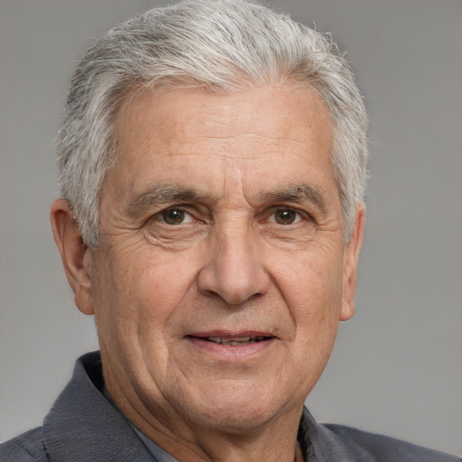 Joyful white middle-aged male with short  gray hair and brown eyes