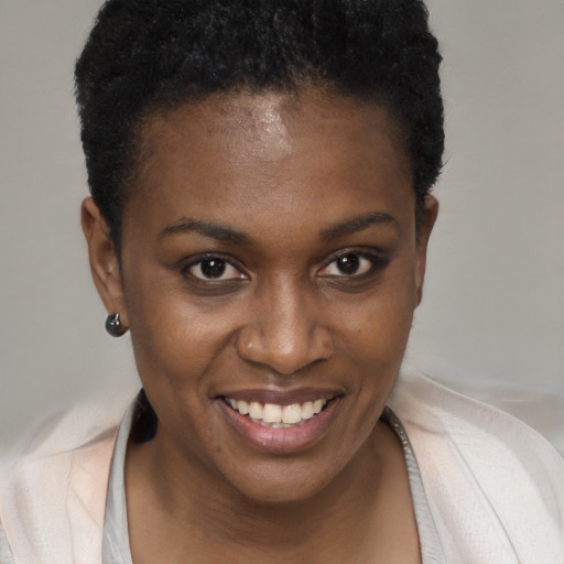 Joyful black young-adult female with short  brown hair and brown eyes