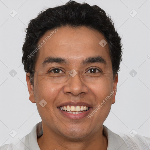 Joyful latino adult male with short  black hair and brown eyes