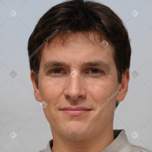 Joyful white adult male with short  brown hair and brown eyes