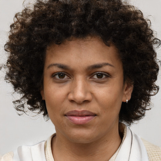 Joyful black young-adult female with medium  brown hair and brown eyes